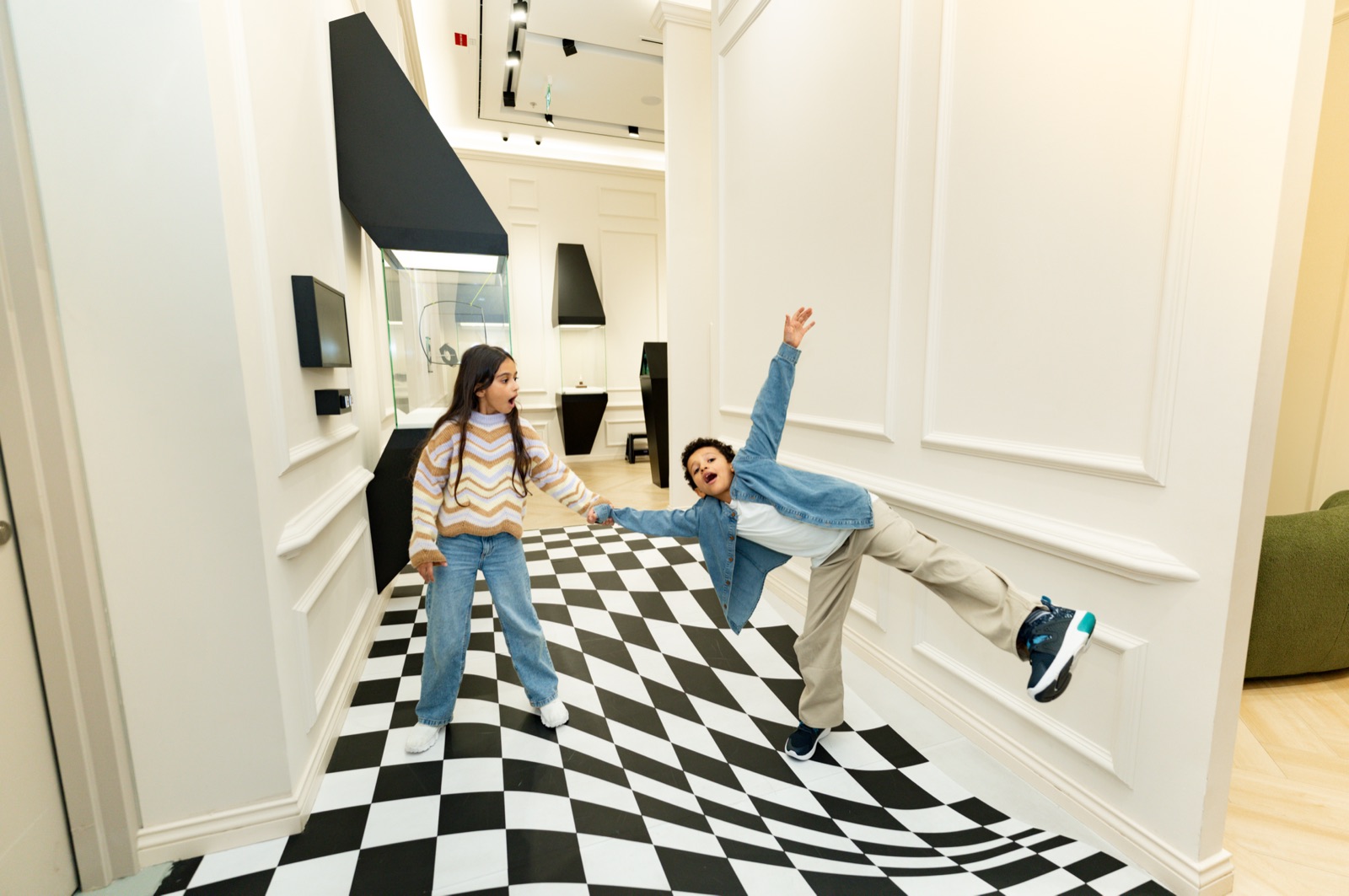 Family enjoying an interactive exhibit at illusion Dubai